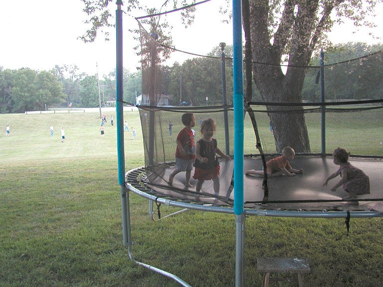 Todd plays with his cousins, while the big kids play softball.