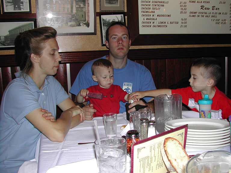 Laurie, Seth, Chad, and Joel wait for dinner in Times Square.
