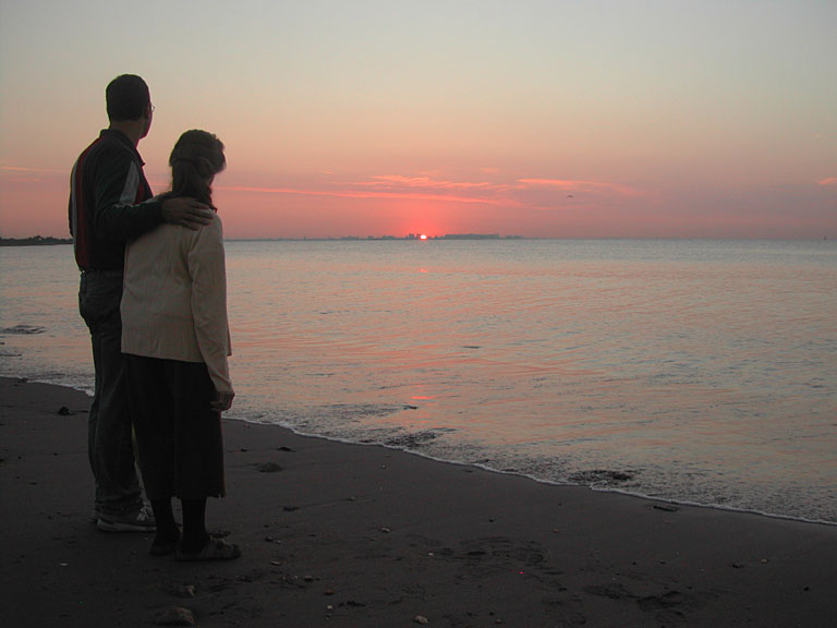 Alan and Mom watch the sun rise over skyline and the Atlantic Ocean.