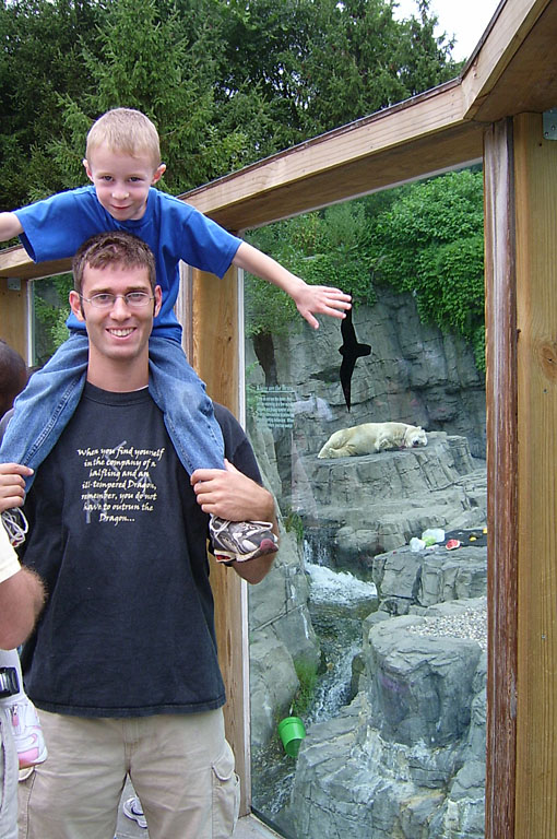 Joel rides on Dan's shoulders through the Central Park Zoo polar bear exhibit.