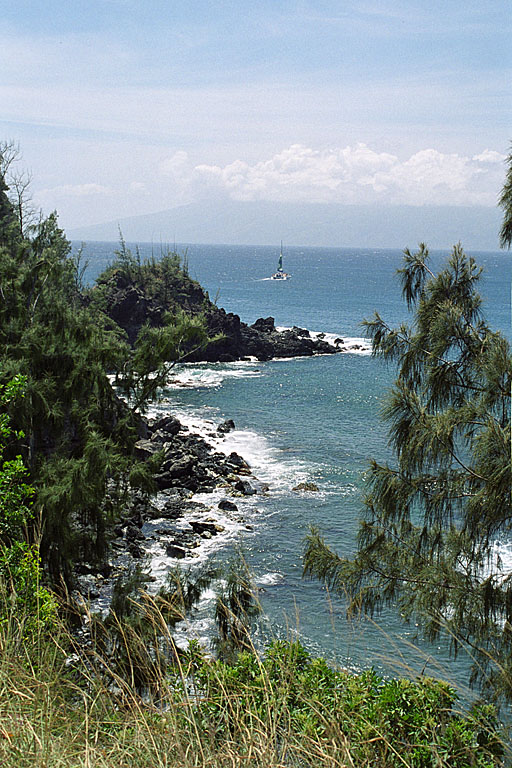 A sailboat going out from the bay.