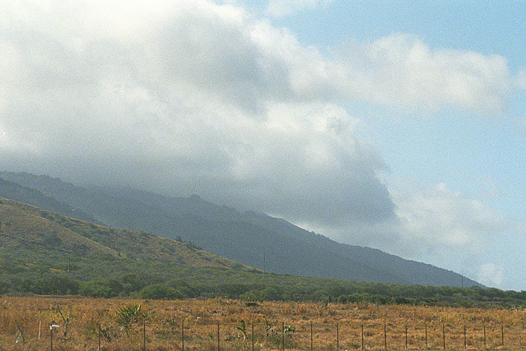The clowds enveloping the mountain.
