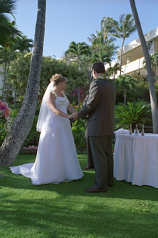 Alan and Jodie hold hands and look at the minister.
