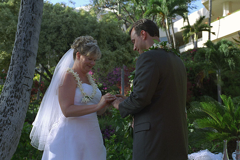 Jodie lovingly puts Alan's wedding ring on his hand.