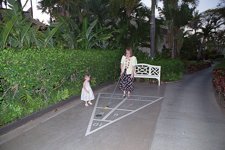 Tammy teaches Sarah how to play shuffleboard.