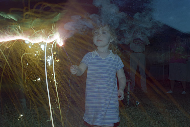 Sarah looking a little like lady liberty with her sparkler.