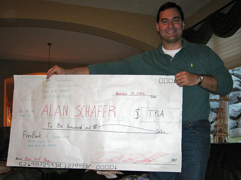 Alan holds up his winner's check.  You've won a golf bag.