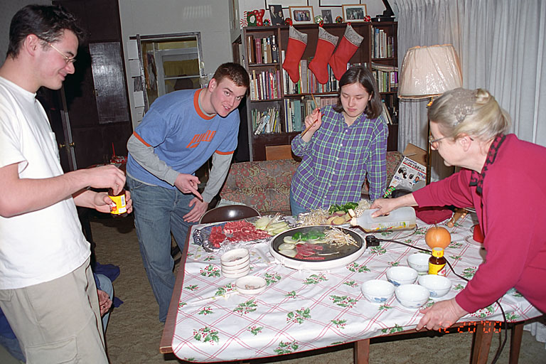 Makato, Joel, Iako, and Marie cook up some food.
