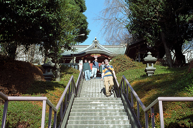 Josh, Kan, Makato, Iako, and Joel walk down the steps of a local temple.