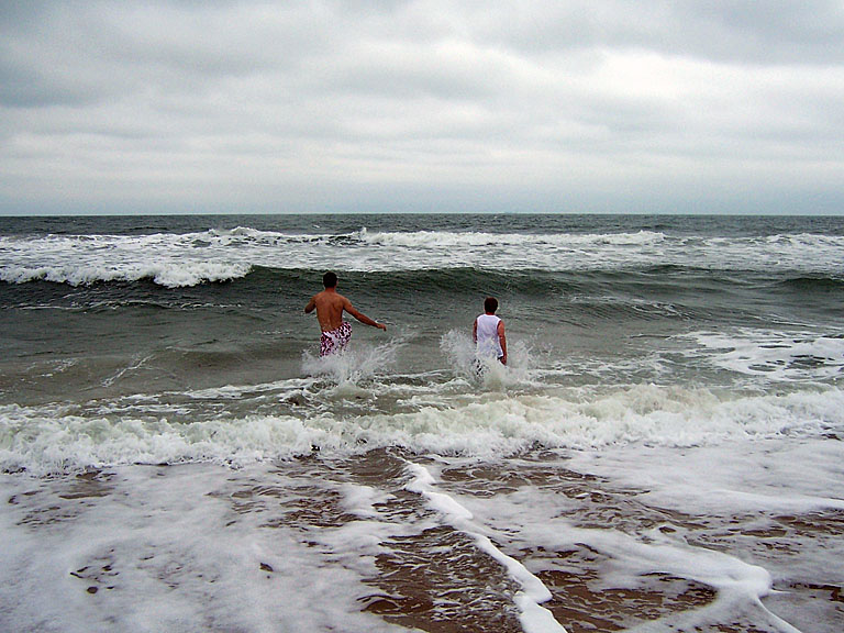 Dan and Jeremy run out into the water.