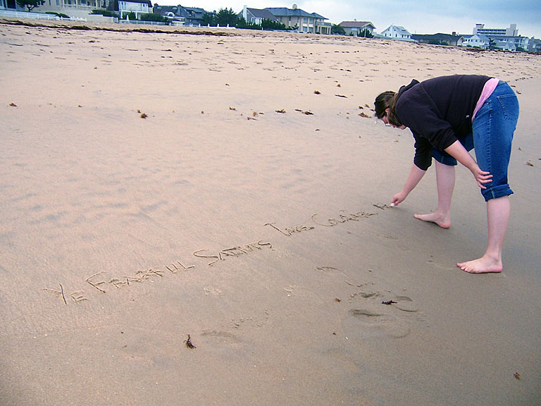 Beth writing her memory verses in the sand.
