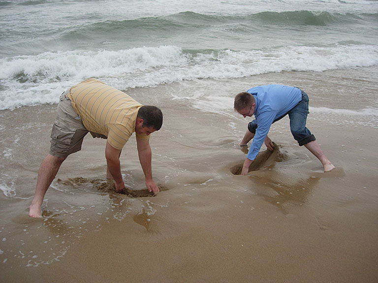 Derrick and Abe dig holes before the water fills them back.
