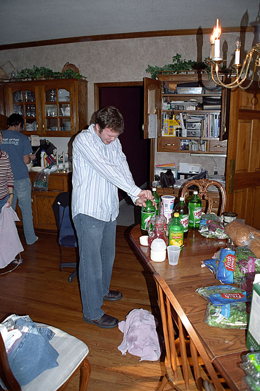 Mark tries in vain to screw the lid back on after it explodes for the second time.