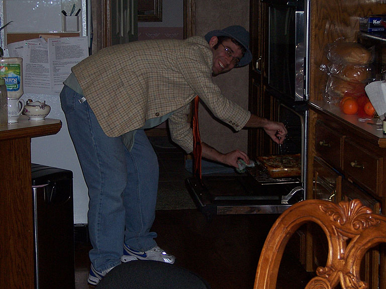Dan checks the lasagna to make sure all the cheese is melted.  Close enough.