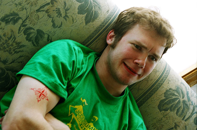 Mark flexes his biceps and his face.