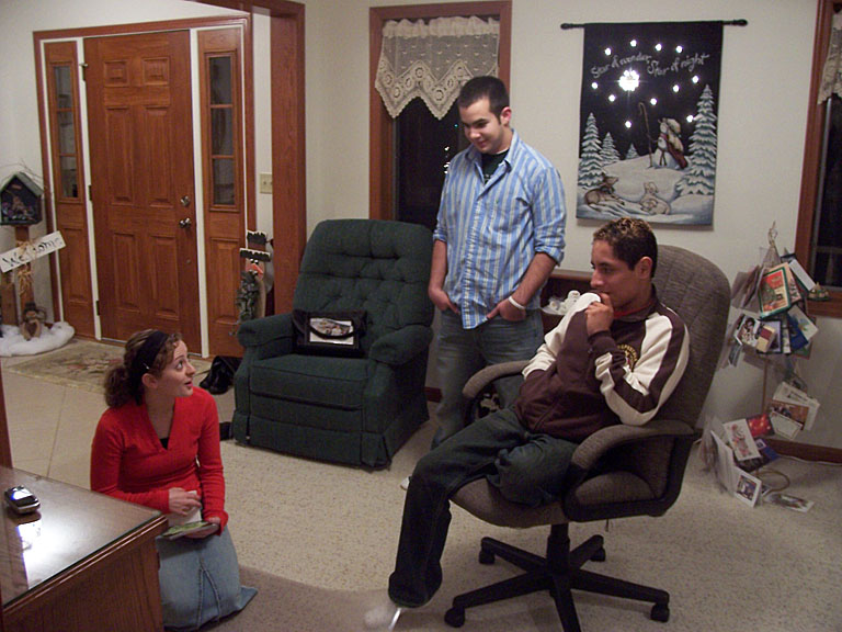 Kristi checks out some photos.  Ben Reinhard and Brian Reinhard look on.