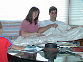 Tammy and Craig look at their new baby blanket from Mom and Dad. (Sarah is on the way)