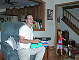 Chad checks out some of their new board games.  Joel wants someone to push his tricycle.
