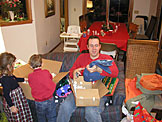 Chad approves his new jeans and firestarters, while Madeline and Joel check the box for more presents.