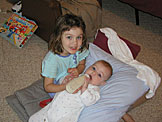 Madeline helps feed Sarah.