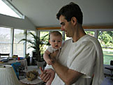 Sarah being held by her proud dad, Craig.