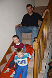 Todd and Joel have fun sliding down the steps on an air mattress with Alan.