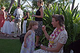 Laurie watches Sarah lean into her bubble blowing.