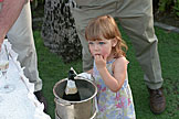 Sarah eats some ice from the wine chiller.