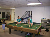 My niece Sarah pays no attention to my nephew's, Todd and Joel, disreguard for the game of pool.