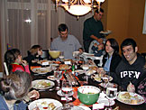 Mom, Madeline, Sarah, Craig, Alan, Michael, Tammy, Dan, and Jodie's hand enjoy Thanksgiving supper.