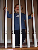 Michael looking through the stair railing.