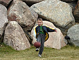 Joel tries to punt the football over everyone's head.