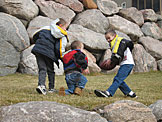 Joel, Seth, and Todd rumble with the football.
