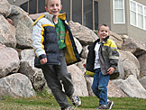 Joel and Todd run around the backyard.
