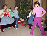 Laurie helps the Todd, Sarah, and Madeline sort through and deliver the Christmas presents.