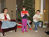 Madeline, Todd, and Joel deliver presents.  Laurie hid one under her chair for added comedy.