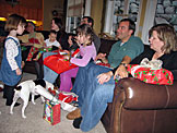 Sarah, Mom, Michael, Tammy, Craig, Madeline, Alan, and Jodie open presents.  Taylor is hoping for more of Michael's Cheerios.