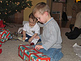 Michael and Seth take their time playing with the wrapping paper.