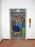 Nick, Abe, Dan, Jeremy, Kyle, Kelby, Derrick, Kristi, Jon, Kyann, Erica, Kirsten, and Beth all squeeze into the elevator in the library.  The library is unfortunately closed.  It seems that Katy has been trapped in a corner of the elevator and cannot be seen.