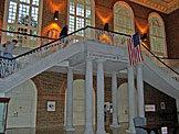 Kyle, Jon, and Kelby race up the steps in the library.