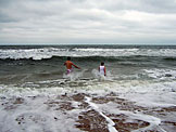 Dan and Jeremy run out into the water.