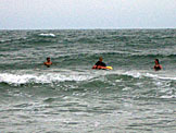 Kyle, Erica, Kelby, and Kirsten in the water.  Kelby is trying to teach Erica to surf.