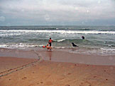 The two fisherman and their dogs set out their driftnet.