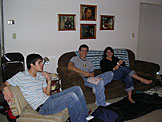 Kyle, Jon, and Erica joke around in the living room at Kelby's apartment while lunch is being prepared.