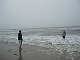Jon wonders why Nick is going out into the water on such a rainy and cold day.