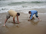 Derrick and Abe dig holes before the water fills them back.