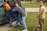 Dan trying to get Sam into the van.  Kristi gets out of the way and Jeremy is an innocent bystander.