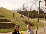 Erica rolls down the hill.  Jeremy watches while Kami and Kelby are shocked that Erica didn't get any grass stains.