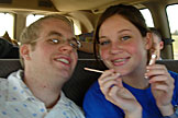 Kelby and Kirsten try on some lip gloss...Jeremy laughes in the back seat.
