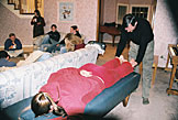 Erica being ''chiropractored'' by Dennis.  Sam, Jon, April, Kirsten, Mark, and Christy enjoy each others company.